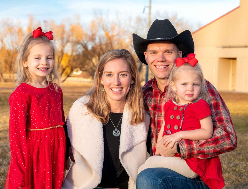 The Perfors Family smiling and dressed for the holidays