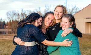 Three friends hugging Lauren